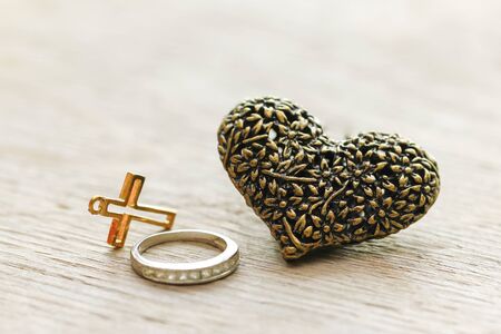 Valentine's day concept - Black heart jewellery pendant on wooden background.の写真素材