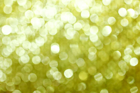 Christmas gold background. Golden holiday glowing backdrop. Defocused Background With Blurred Bokehの写真素材
