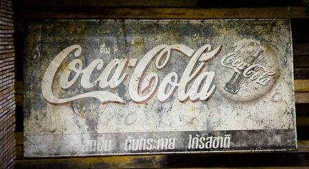 Bangkok, Thailand - January 13,2018 : The old rust condition vintage of Coca Cola sign on the wooden...