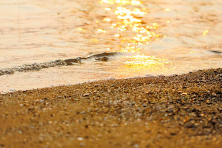 Colorful sunset on the tropical beach, orange sunset over sea,Sunlight hits the surface,sea wave on the beach with sunlight on sunset time at the beach.の写真素材