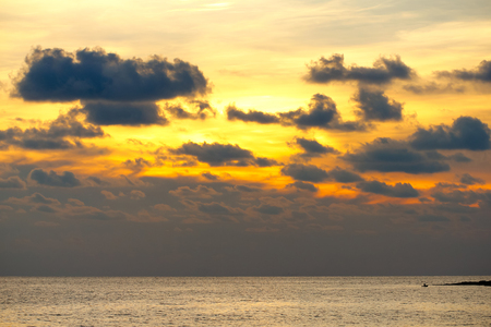 Dramatic sunset sky with clouds over ocean.の写真素材