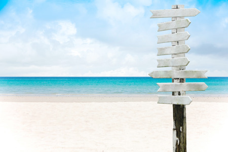 old wooden signboard on tropical beach.Summer Holidays background. Palm leaves, fluffy clouds, blue sea, white sand. Tropical beach.の写真素材