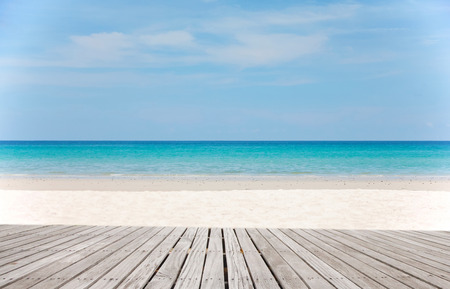 Empty wooden pier with view on sandy beach. Free space for text or product placement.Summer Holidays...