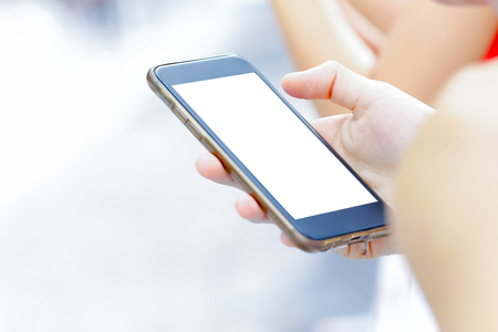 Technology and communication concept. Cropped shot of a woman's hand holding mobile phoneの写真素材