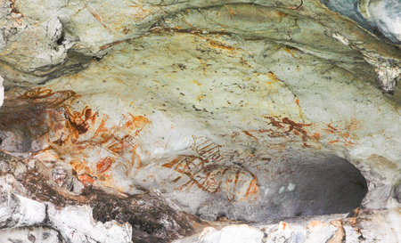 Archaeological pre-historic human cliff paint over 3,000 years ago, khao-khian-ao-phang-nga-national-park, Thailand. Cave paintings of primitive man on sand stone. ocher paint.の写真素材