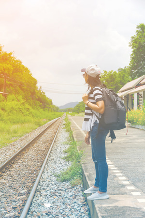 Closeup a beautiful woman with backpack on the railway platform. Travel and vacation concept.の写真素材
