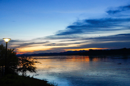 Sunset sky over water landscape. Sunset sky clouds over sunset river. Sunset river water viewの写真素材