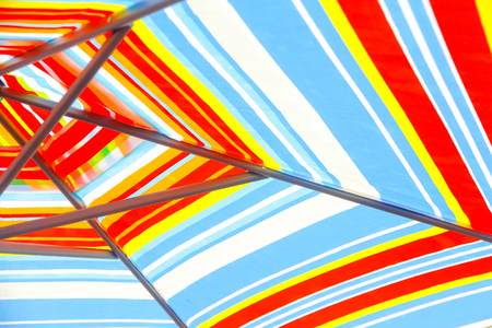 Striped umbrellas at city alleyの写真素材
