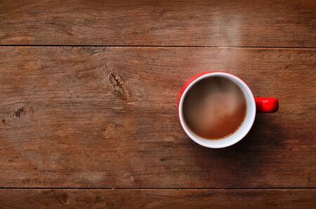 red cup coffee on wood background 