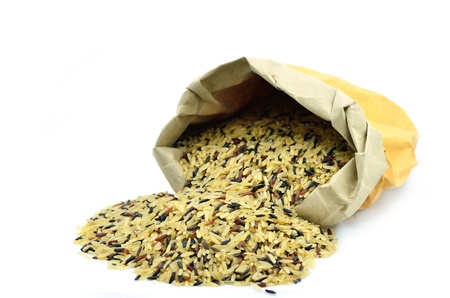Raw long grain white rice grains in paper bagの写真素材