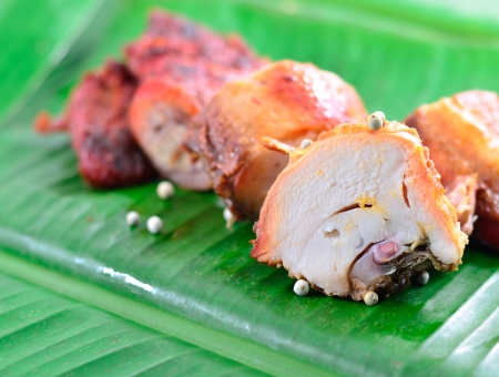 slice of roasting chicken on green dishの写真素材