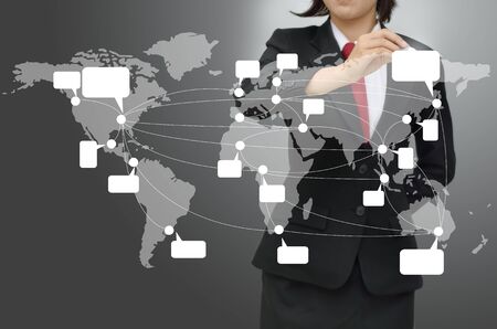 Business woman drawing world map with cloud computing and social network conceptの写真素材