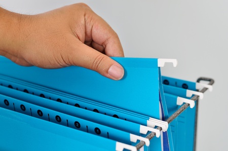 Close up male hand holing blue paper folderの写真素材