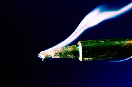 Close up Hot soldering iron with smokeの写真素材