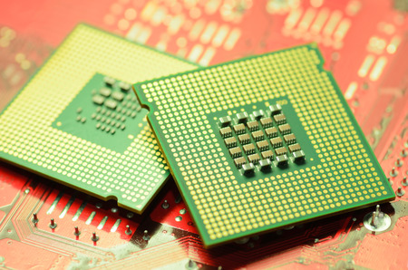 computer cpu  central processor unit  chip on mainboard close upの写真素材