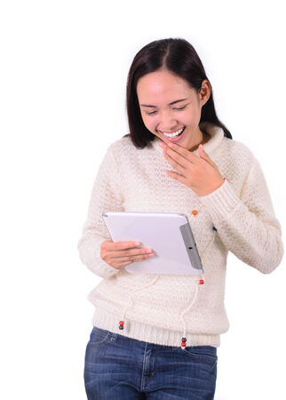 Asian student happy leaning and holding a computer tablet Isolatedの写真素材