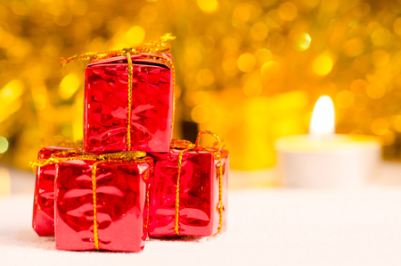 christmas scene and new year background for art design with red gift box, snow gold bokeh backgroundの写真素材