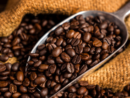 Close up coffee bean with bag and spoon on wood backgroundの写真素材