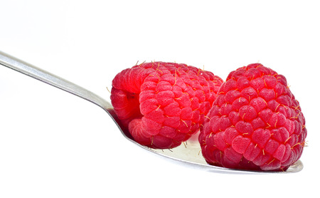 raspberry fruit on spoon isolate on white backgroundの写真素材