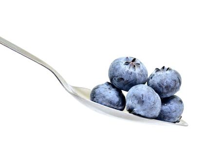 blue berry on spoon isolated on white background for designの写真素材
