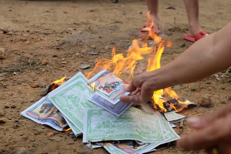 Burning silver paper to pay respect to ancestors in the Chineseの写真素材