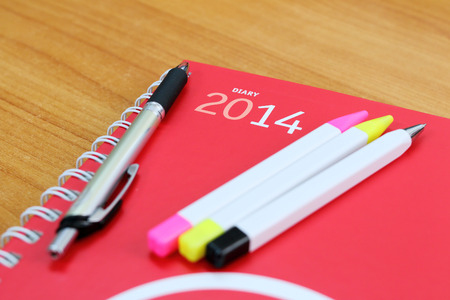 Notepad with cover of leaf lies on wooden board の写真素材