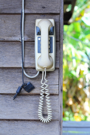 Retro phone on a wooden wall の写真素材