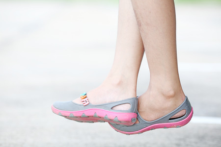 woman feet in and flip flop sandals の写真素材