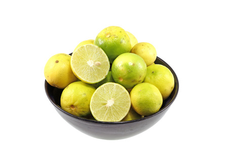 Lemons in black cup on white background.の写真素材
