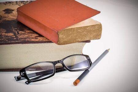 Red book and eyesglass on vintage style