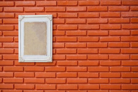 Old wooden frame on the grunge brick wallの写真素材