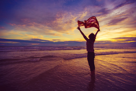 Freedom Concept. Beautiful Girl With  Scarf on The Beach enjoying summer.vintage style.の写真素材