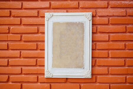 Old wooden frame on the grunge brick wallの写真素材