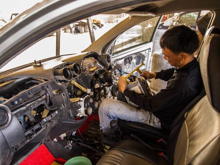 A car mechanic working in a car alone.の写真素材