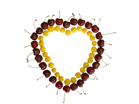 Fruit arranged in a beautiful heart on a white background.