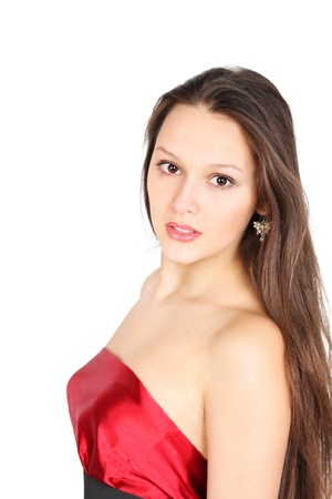 Cute brunette girl wearing red dress looks at camera isolated on white backgroundの写真素材