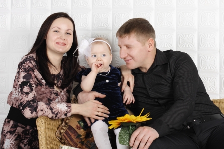 Happy beautiful mother, father and their little cute daughter.の写真素材