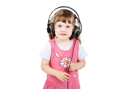 Little happy girl in big headphones looks at camera isolated on white background.の写真素材