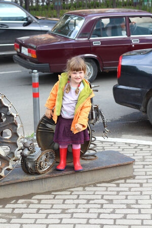 Little girl near city sculpture Parade of Planets near Crystal cinemaの写真素材