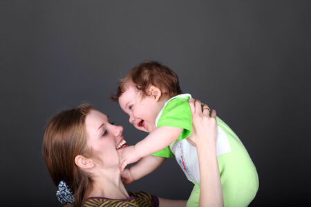 Portrait of happy female playing with her cute little son の写真素材