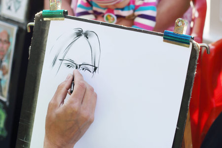 PERM, RUSSIA - JUN, 23, 2014: Hand of street artist in Gorky Park. Gorky Park was founded in 19th centuryのeditorial素材
