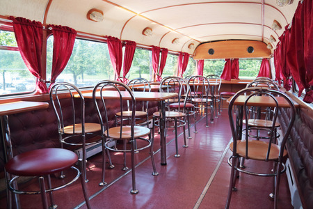 PERM, RUSSIA - JUN 11, 2013: Tables in double-decker bus cafe Kentucky Fried Chicken. First restaurant KFC was opened in 1930のeditorial素材