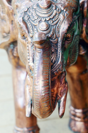Copper figurine with green spots Indian elephant with tusks and raised trunkの写真素材