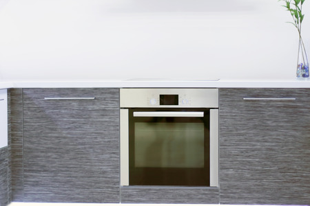 Built-in oven in new modern kitchen with grey wooden furnitureの写真素材