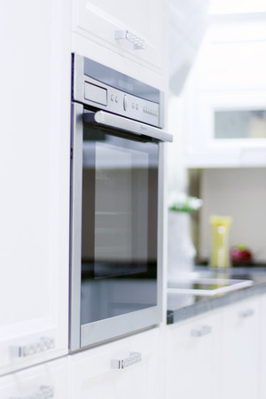 Built-in oven in new modern kitchen with white wooden furnitureの写真素材