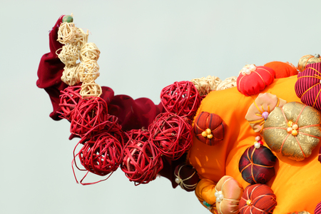 Beautiful orange composition with straw and fabric balls for decorationの写真素材