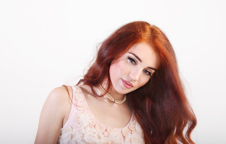 Portrait beautiful young smiling girl with red long hair and dressの写真素材