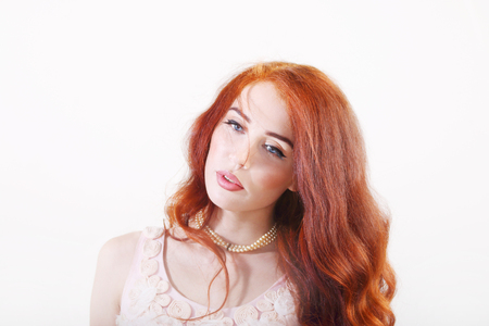 Closeup portrait beautiful young smiling girl with red long hairの写真素材