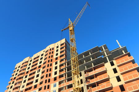 PERM, RUSSIA - FEB 17, 2015: Big stationary hoist and building under construction. In 2014 residential buildings were built in record number in Russiaのeditorial素材