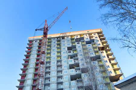 PERM, RUSSIA - FEB 17, 2015: Stationary hoist and building under construction. In 2014 residential buildings were built in record number in Russiaのeditorial素材